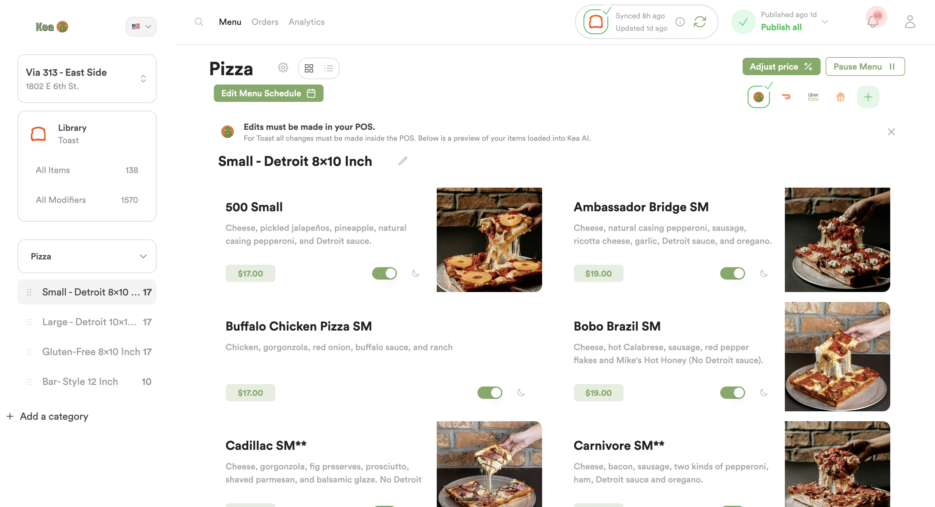 This image shows a user interface screen for managing a pizza menu, specifically focusing on the category of Small Detroit style 8x10 inch pizzas. The interface allows editing of menu items, prices, and availability toggles. It lists various pizza options such as '500 Small', 'Ambassador Bridge SM', 'Buffalo Chicken Pizza SM', 'Bobo Brazil SM', 'Cadillac SM', and 'Carnivore SM', each with descriptions of their toppings and prices ranging from $17.00 to $19.00. The menu appears integrated with a POS system, with a note emphasizing that edits must be made within the POS. The layout includes images of each pizza variant, a sidebar menu navigation, options to adjust pricing, pause the menu, and an indicator showing synchronization and publishing status. This interface would be useful for restaurant staff or managers to update and control their pizza offerings digitally.