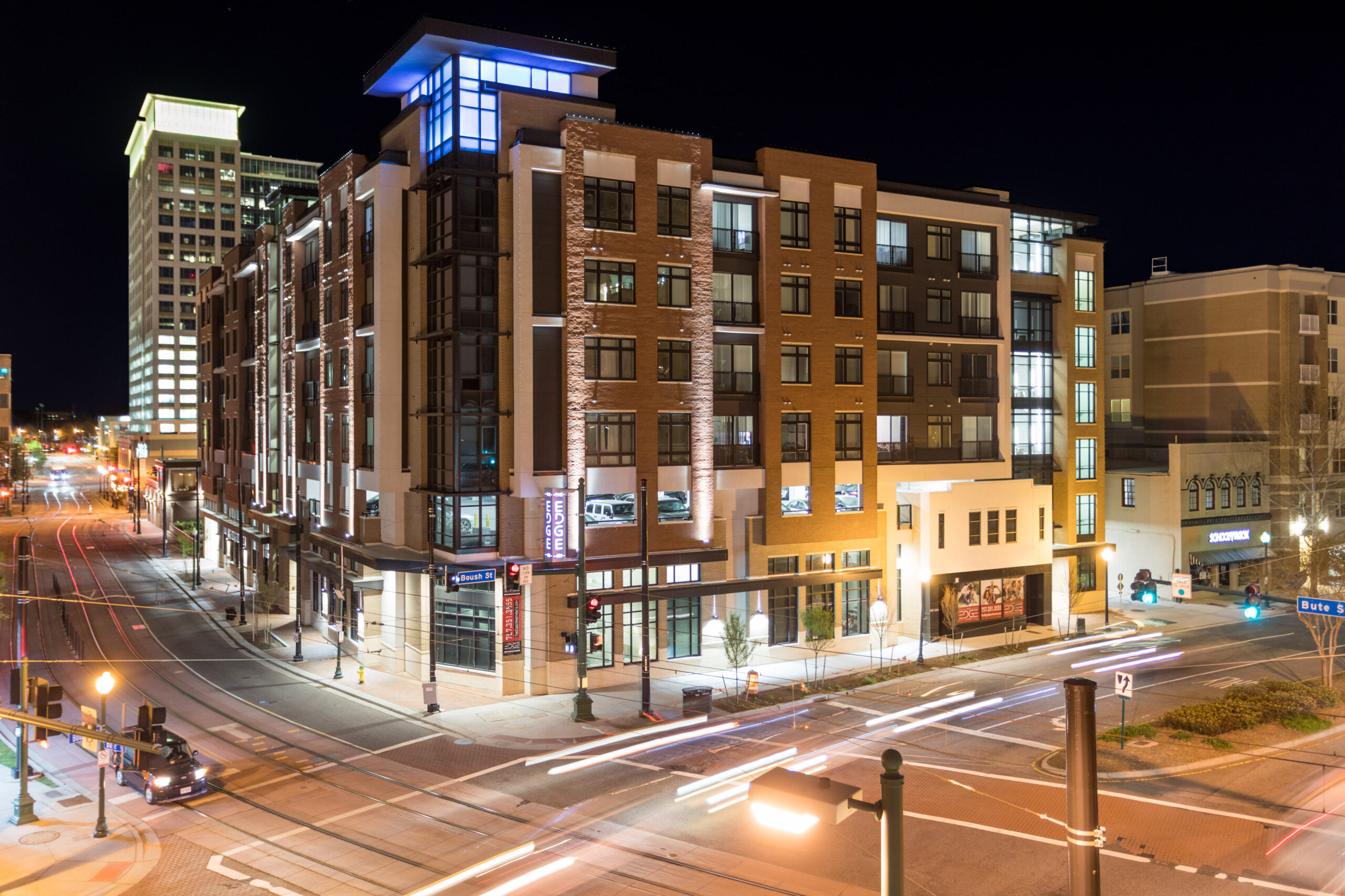 Modern Residential Building at Night in Downtown Intersection