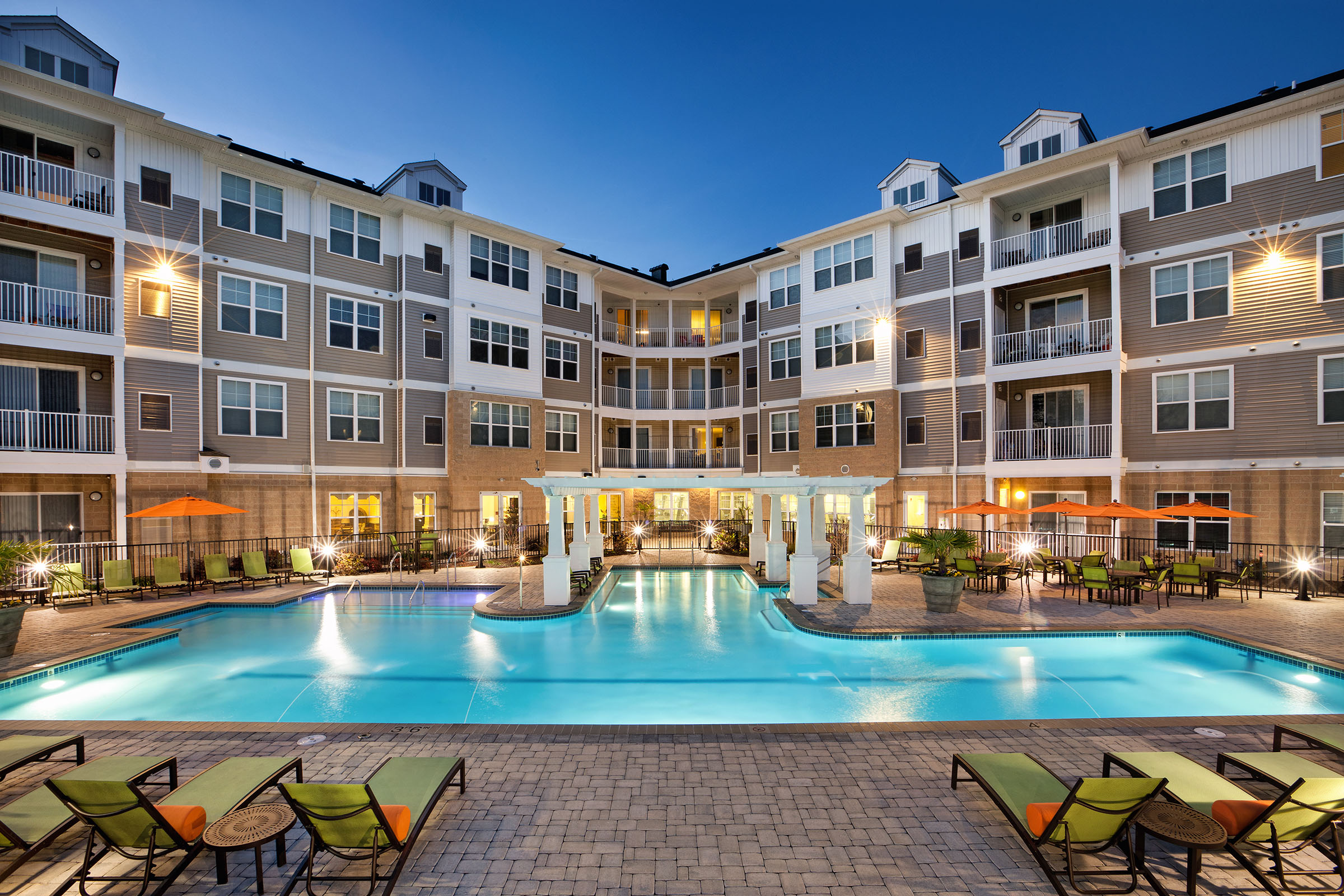 Luxury Apartment Complex with Evening Swimming Pool View